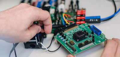 Person working on computer circuit boards